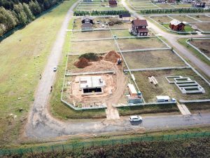 Aeriial view of excavation works and construction area with unfinished houses.
